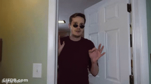A Man Wearing Sunglasses Is Standing In A Doorway With Imgflip.com Written On The Bottom GIF