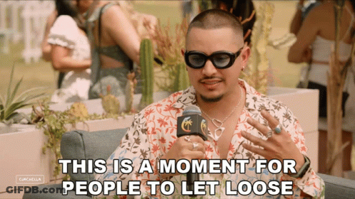 A Man Wearing Sunglasses Is Talking Into A Microphone With The Words " This Is A Moment For People To Let Loose " Below GIF