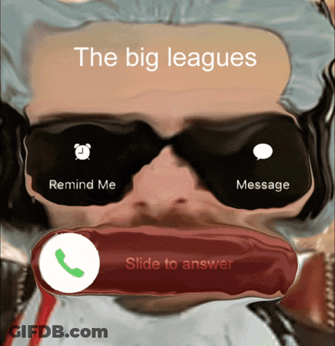 A Man Wearing Sunglasses Is Talking On A Phone With The Big Leagues Written Above Him GIF