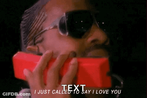 A Man Wearing Sunglasses Is Talking On A Red Phone And Says I Just Called To Say I Love You . GIF