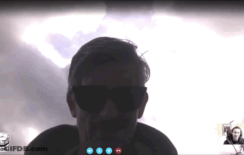 A Man Wearing Sunglasses Is Talking On A Video Call GIF