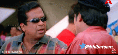 A Man Wearing Sunglasses Is Talking To Another Man With The Twitter Username @Bhibatsam GIF