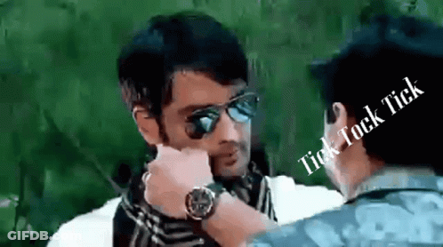 A Man Wearing Sunglasses Is Talking To Another Man With The Words Tick Tock Tick Above Him GIF