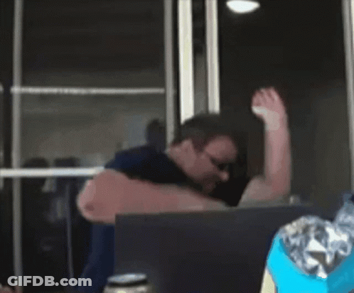 A Man Wearing Sunglasses Is Using A Laptop GIF