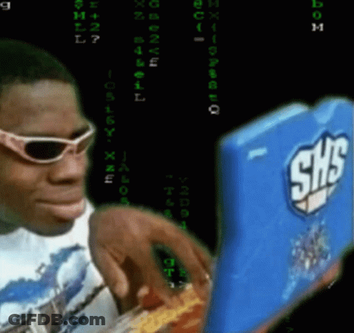 A Man Wearing Sunglasses Looks At A Shs Laptop GIF