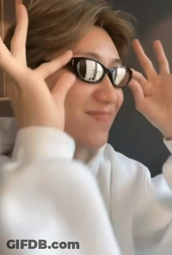 A Man Wearing Sunglasses Makes A Funny Face With His Hands GIF