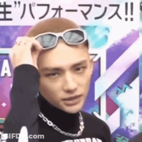 A Man Wearing Sunglasses On His Head Is Making A Face . GIF