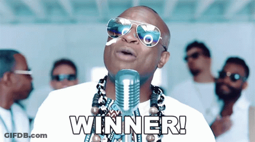 A Man Wearing Sunglasses Singing Into A Microphone With The Word Winner Written Below Him GIF