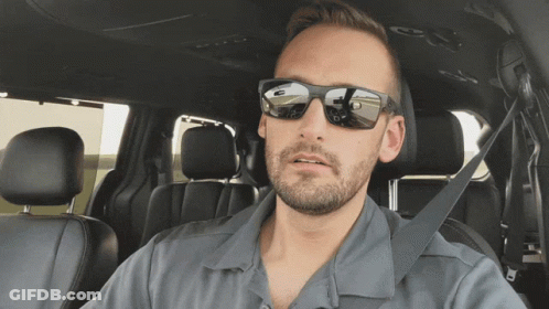 A Man Wearing Sunglasses Sits In A Car GIF