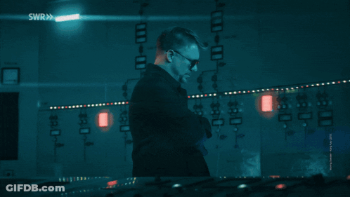 A Man Wearing Sunglasses Stands In Front Of A Screen That Says Hackerman GIF