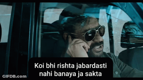A Man Wearing Sunglasses Talks On A Cell Phone In A Car GIF