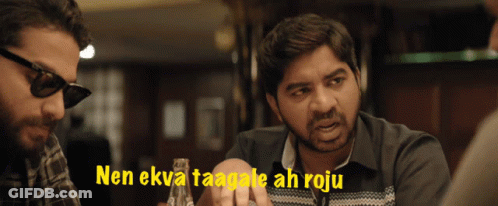 A Man Wearing Sunglasses Talks To Another Man With The Words " Nen Ekva Taagale Ah Roju " Behind Him GIF