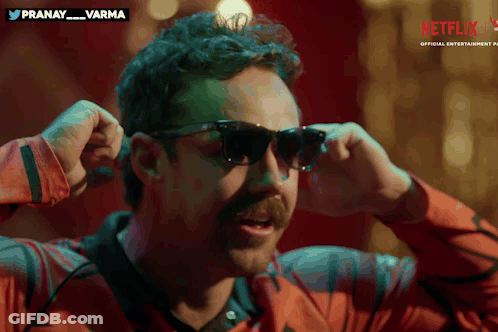 A Man Wearing Sunglasses With A Netflix Logo On The Bottom Right GIF