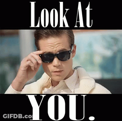 A Man Wearing Sunglasses With The Words Look At You Behind Him GIF