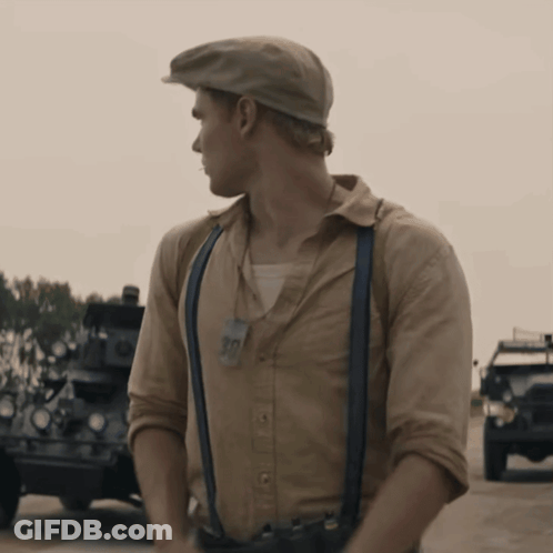 A Man Wearing Suspenders And A Hat With A Tag That Says 90 GIF