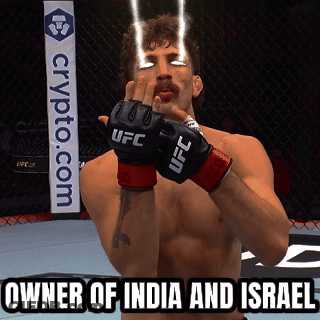 A Man Wearing UFC Gloves Stands In Front Of A Crypto.com Banner GIF