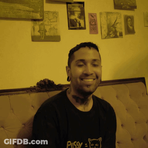 A Man Wears A Black Shirt That Says Pussy On It GIF