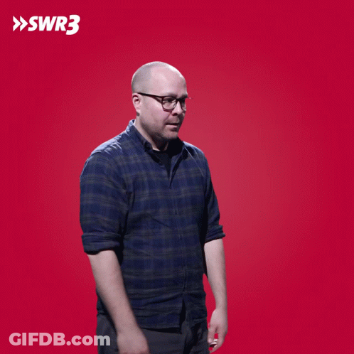 A Man Wipes His Eyes In Front Of A Red Background With The Letters Swr3 On It GIF