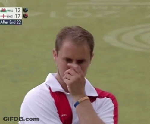 A Man Wipes His Nose In Front Of A Scoreboard That Says " After End 22 " GIF
