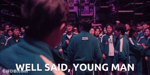 A Man With 226 On His Back Stands In Front Of A Crowd GIF