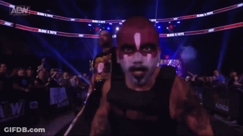 A Man With A Aew Logo On His Shirt GIF