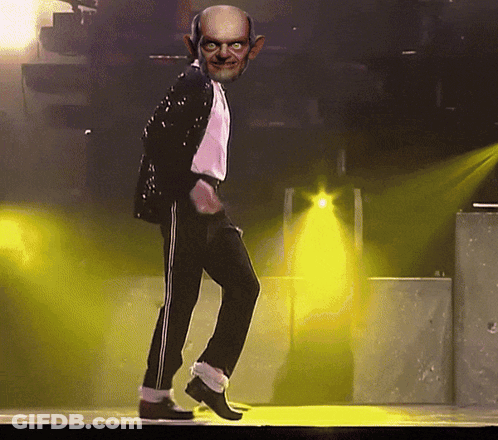 Bald Man Dancing On Stage With Yellow Lights GIF