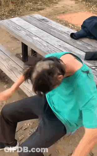 A Man With A Bald Head Is Sitting On A Bench GIF