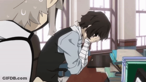 Man With Bandage Sitting At Desk With Head In Hands GIF