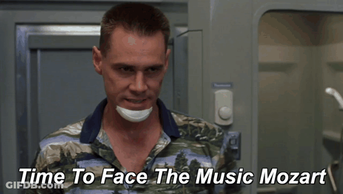 A Man With A Bandage On His Face And The Words Time To Face The Music Mozart Behind Him GIF