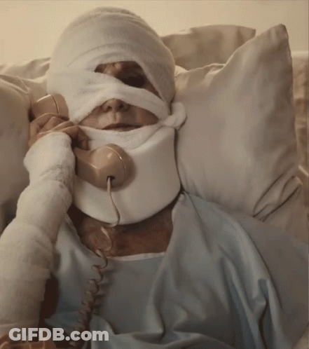 A Man With A Bandage On His Face Is Talking On A Telephone GIF