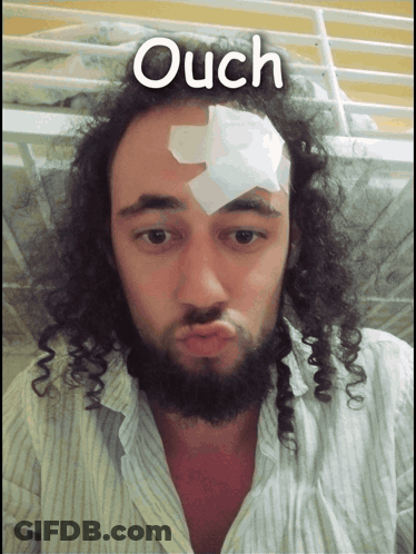 A Man With A Bandage On His Forehead Has The Word Ouch Written Above Him GIF