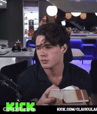 A Man With A Bandage On His Forehead Is Holding A Box With The Words Kick.com/clavicular Below Him GIF