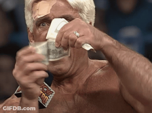 A Man With A Bandage On His Forehead Is Holding A Stack Of Money In Front Of His Face GIF