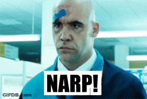 A Man With A Bandage On His Forehead Is Standing In A Room With The Word Narp . GIF