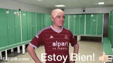A Man With A Bandage On His Head Is Giving A Thumbs Up In A Dressing Room . GIF
