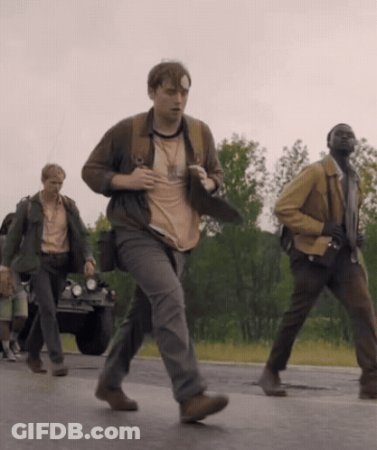 A Man With A Bandage On His Head Is Running Down The Road GIF