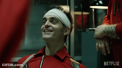 A Man With A Bandage On His Head Is Smiling In Front Of A Netflix Ad GIF