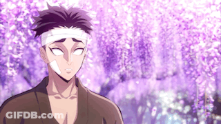 A Man With A Bandage On His Head Is Standing In Front Of A Purple Flowering Tree . GIF