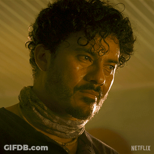 A Man With A Bandana Around His Neck And A Netflix Logo On The Bottom Right GIF