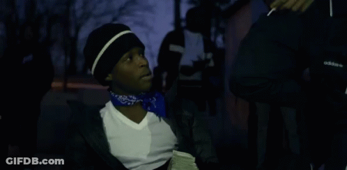 A Man With A Bandana Around His Neck Is Holding A Bunch Of Money GIF