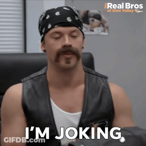 A Man With A Bandana On His Head And A Mustache Says I 'M Joking GIF