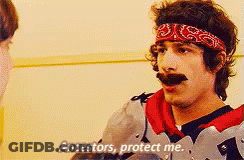 A Man With A Bandana On His Head Is Talking To Another Man And Says Ancestors Protect Me GIF