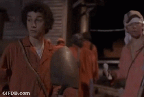 A Man With A Bandana On His Head Talks To Another Man With The Words Smaller Shovel Written Below Them GIF