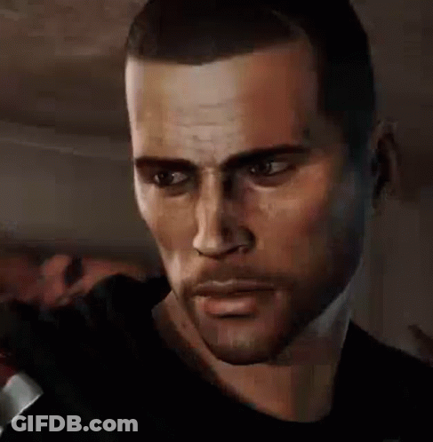 A Man With A Beard And A Black Shirt Is Looking At The Camera . GIF