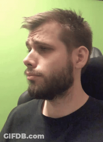 A Man With A Beard And A Black Shirt Is Making A Face GIF