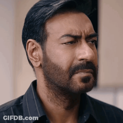 A Man With A Beard And A Black Shirt Looks To The Side GIF