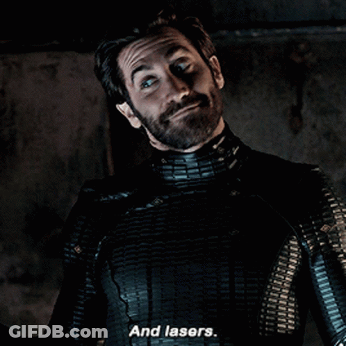 A Man With A Beard And A Black Suit Says And Lasers GIF