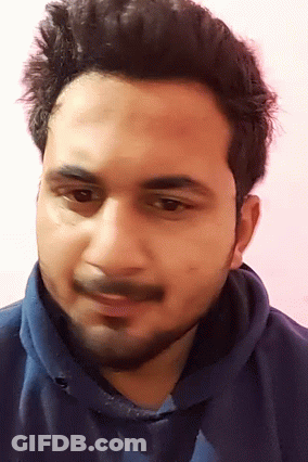 A Man With A Beard And A Blue Shirt Is Smiling GIF