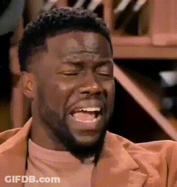 A Man With A Beard And A Brown Jacket Is Making A Funny Face . GIF