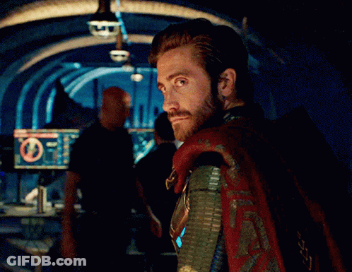 A Man With A Beard And A Cape Is Standing In Front Of A Computer Monitor With A Circle In The Middle GIF